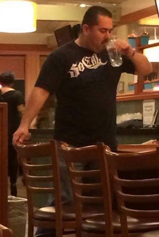 Ramos guzzles a drink before leaving the establishment. "Killer cops aren't welcome here," read the caption.