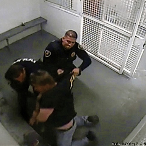 Raw Video Shows Cops Ramming Handcuffed Man Into Wall, Kneeing Him